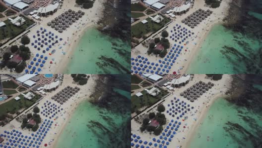 无人机拍摄的风景如画的尼斯沙滩在塞浦路斯，清澈的绿松石水和岩石底部高清在线视频素材下载