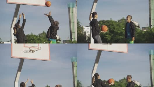 早上，一名亚裔中国老人和他的女儿在篮球场练习篮球高清在线视频素材下载