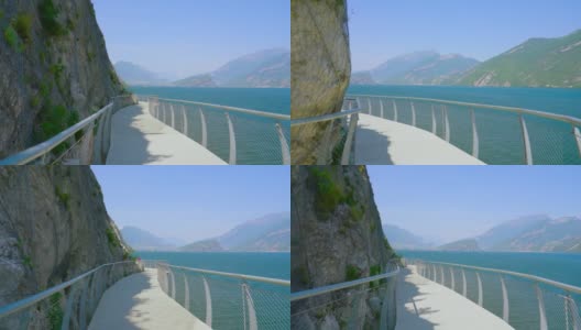 路悬在山上的岩石上，通往阿尔卑斯山的湖泊高清在线视频素材下载