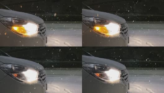 汽车的前灯照亮了雪景。缓慢的运动。高清在线视频素材下载