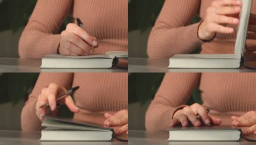 女人合上笔记本，把手放在封面上高清在线视频素材下载