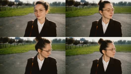 穿大衣戴眼镜的女人在公园里散步高清在线视频素材下载
