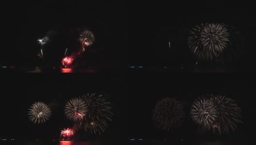 奇妙的多色烟花与烟雾的4k镜头从海上的大船上的夜空背景，庆祝概念，高清在线视频素材下载