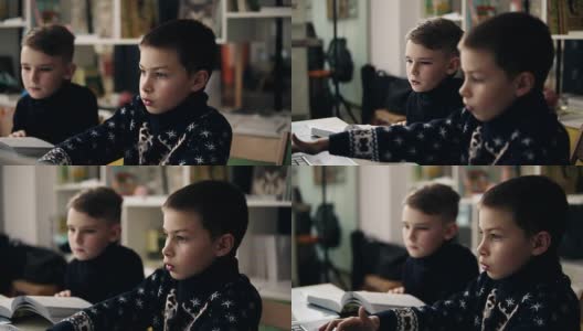 两个小男孩坐在笔记本电脑前的慢镜头。编程类。儿童的替代性教育。高清在线视频素材下载