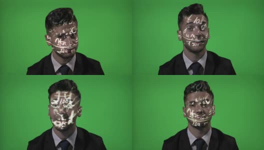 年轻的男大学教授使用增强现实的数学全息公式投影在他的脸在绿色屏幕的背景高清在线视频素材下载