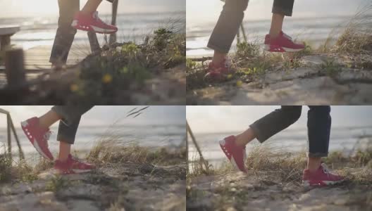 女孩在粉红色的运动鞋踩沙丘无脸近距离慢镜头阳光明媚多风的夏天早晨。女性探险家采取禁止的路径，因为不同的改变规则。改变冠军的决心高清在线视频素材下载