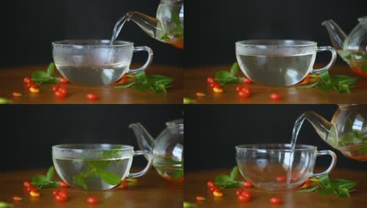 用玻璃茶壶盛着熟透的红枸杞的热茶高清在线视频素材下载