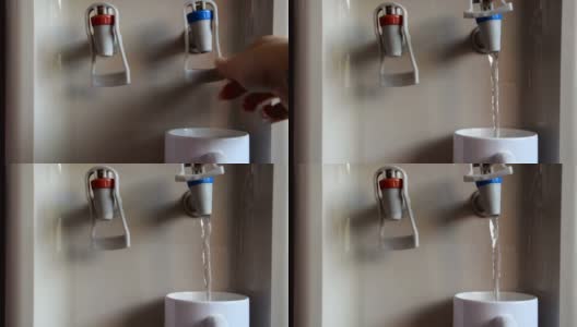 女人的手从饮水机里拿出一个白色的杯子盛水高清在线视频素材下载