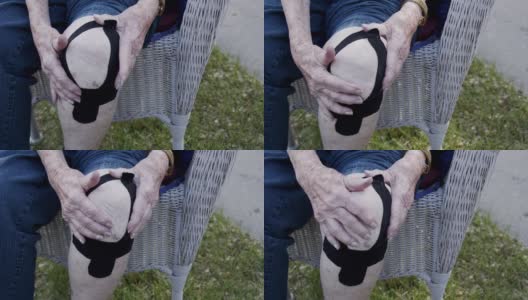 特写镜头老年白人妇女的膝关节关节炎疼痛在正午户外在夏天高清在线视频素材下载