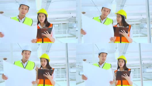 年轻的亚洲男女工程师戴着头盔走过建筑工地，为他们的项目制定计划，监督建筑工地高清在线视频素材下载