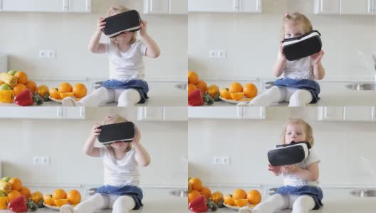 俄罗斯乌法——2017年4月:小女孩在厨房里使用虚拟现实眼镜高清在线视频素材下载