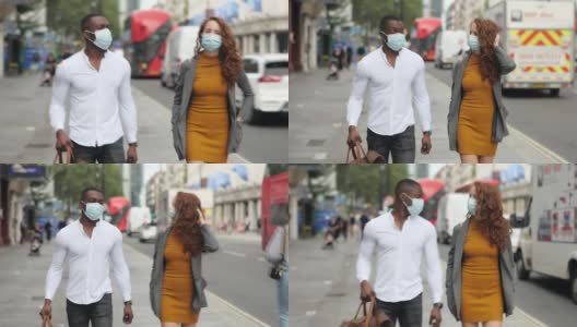 一对夫妇戴着防护口罩走在繁忙的伦敦大街上高清在线视频素材下载