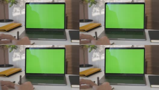 女孩看绿色屏幕的笔记本电脑在客厅看视频高清在线视频素材下载