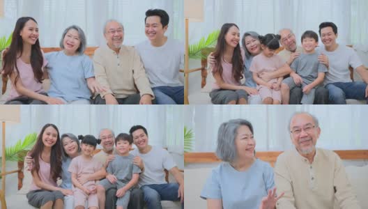 一个快乐的亚洲大家庭在家里的客厅里一起度过时光。孩子们坐在爷爷奶奶的腿上，爸爸妈妈在旁边。多代关系和家庭活动。高清在线视频素材下载