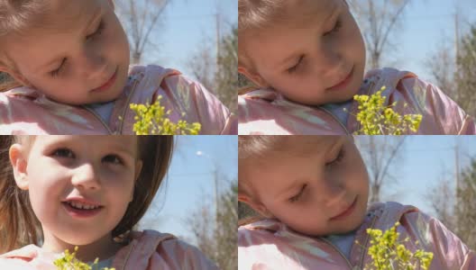 快乐的孩子在户外享受大自然。春天。画一个闭着眼睛微笑的女孩。美丽的白日做梦的小女孩捧着一束春天的黄花高清在线视频素材下载