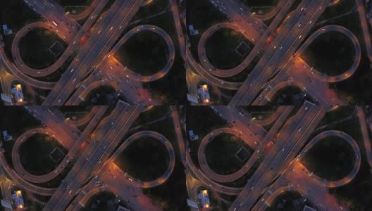 无限高速公路立交桥鸟瞰图，繁忙的城市交通在夜间高速行驶高清在线视频素材下载