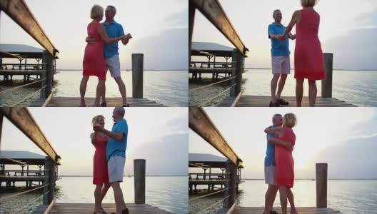 日落时分，健康的白人老年人在码头上跳舞高清在线视频素材下载