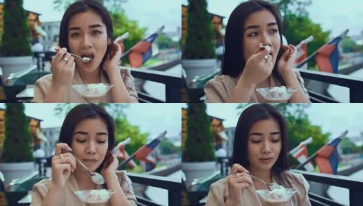 可爱和美丽的亚洲女人与冰淇淋高清在线视频素材下载