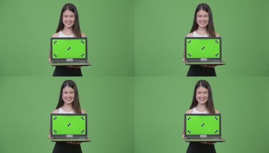 年轻美丽的亚洲女商人展示笔记本电脑高清在线视频素材下载