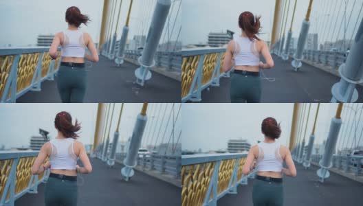 年轻女子慢跑过桥，慢镜头高清在线视频素材下载