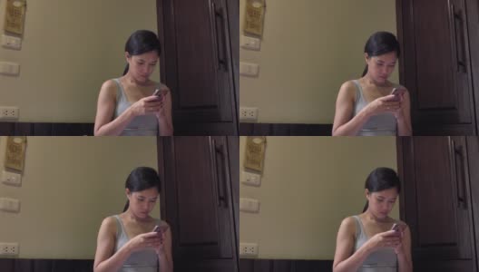 亚洲女人在酒店房间玩智能手机高清在线视频素材下载