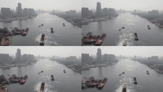 无人机在大城市的一条可航行的河流上空飞行高清在线视频素材下载