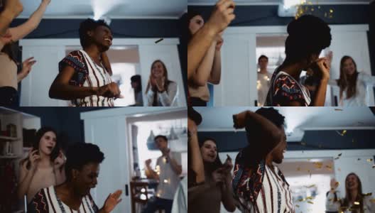 快乐的年轻非洲女学生史诗有趣的舞蹈与大学朋友在五彩纸屑生日派对慢镜头。高清在线视频素材下载