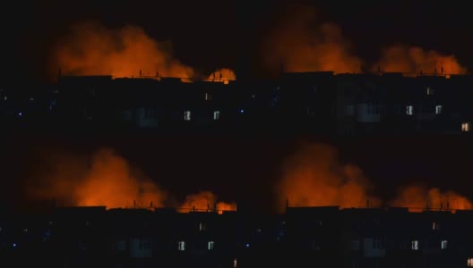 乌克兰，夜色中的城市，映衬着一座房子的剪影。火灾灾难和事故悲剧概念。高清在线视频素材下载