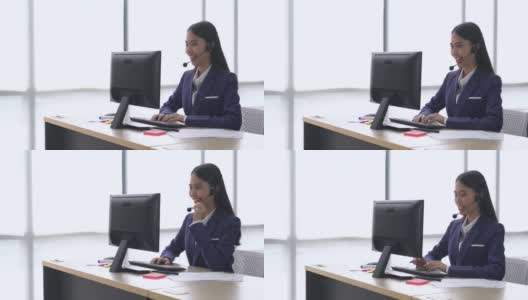 美丽年轻快乐微笑的女性客户支持电话接线员在工作场所，高清在线视频素材下载
