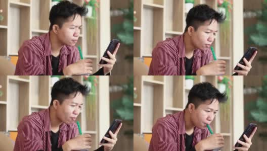 年轻人在咖啡馆喝酒玩手机高清在线视频素材下载