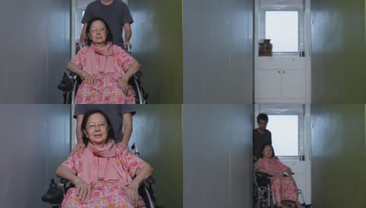 亚洲成年男子照顾他的母亲在轮椅上高清在线视频素材下载