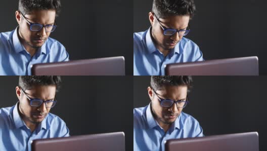 一个年轻人用笔记本电脑窃取个人信息高清在线视频素材下载
