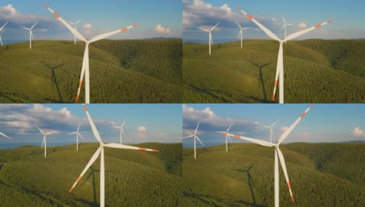 空中特写镜头风力磨坊旋转的力量，并产生可再生能源在绿色生态的方式，以太阳照耀地球。高清在线视频素材下载