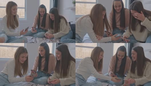 一群十几岁的女孩在家里的卧室里用手机高清在线视频素材下载