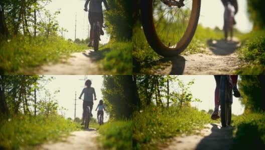 在一个阳光明媚的日子里，骑自行车的人的腿，两个年轻的女孩在绿色的森林小径上经过高清在线视频素材下载