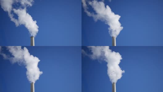 一个烟囱吹烟雾或水汽我们的塔在晴朗的天空背景-近距离高清在线视频素材下载