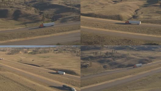 空中摄影:半卡车和汽车在风景优美的乡村丘陵公路上行驶高清在线视频素材下载