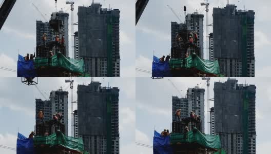 建筑工地工人，香港在建的摩天大楼。高清在线视频素材下载