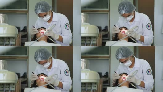 牙医正在检查病人的牙齿。妇女工作的病人的牙痛和牙科保健卫生高清在线视频素材下载