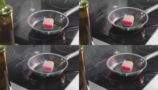 煎鱼，马林鱼片放在热气腾腾的煎锅上。高清在线视频素材下载