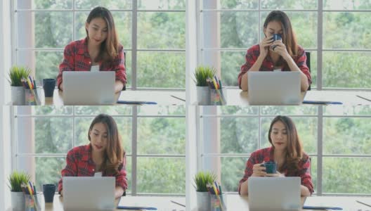 年轻的亚洲女性工作与笔记本电脑和喝咖啡在家办公与快乐的情绪，在家里工作，小企业，在线商务，在线教育，办公室休闲的生活方式概念高清在线视频素材下载