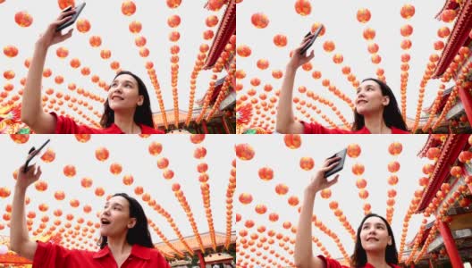 女人拍照的许多中国灯笼在神社。高清在线视频素材下载