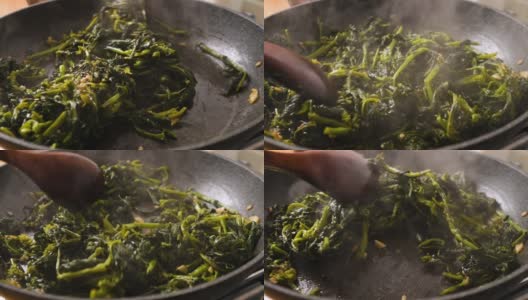 用慢动作在煎锅中烹煮并搅拌菠菜、friarielli高清在线视频素材下载