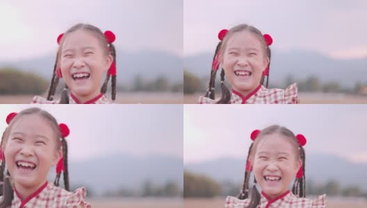 穿着旗袍的亚洲女孩在公园里笑高清在线视频素材下载