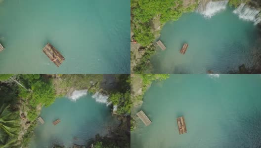 无人机从空中拍摄的年轻女子在热带瀑布竹筏。4K分辨率的视频，在菲律宾拍摄。人们旅行乐趣度假冒险概念高清在线视频素材下载