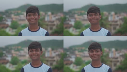 一名印度少年的肖像，一边盯着镜头一边微笑。上学的青少年对着镜头微笑。积极情绪高清在线视频素材下载