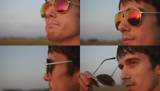 帅气的年轻时尚男子戴着太阳镜，看起来日落在野外高清在线视频素材下载