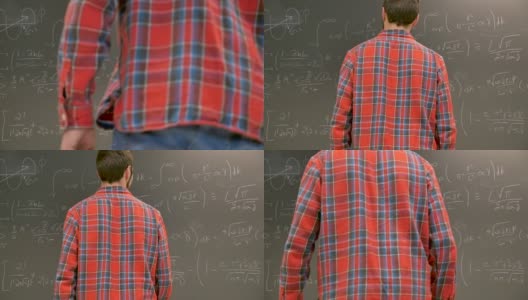 一个年轻的男大学生走到黑板前解一道复杂的数学题高清在线视频素材下载