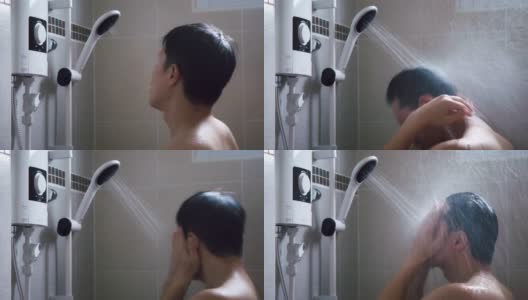 年轻的亚洲男人在浴室里用淋浴洗澡，充满新鲜感。高清在线视频素材下载