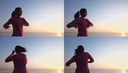 SLO MO美丽的年轻亚洲女子在沙滩上锻炼高清在线视频素材下载